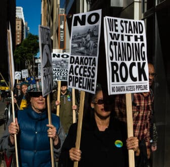 Group of protestors holding signs that read: "We stand with Standing Rock."