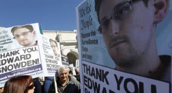 Demonstrators holds up banners with the photo of Edward Snowden during a protest outside of the U.S. Capitol in Washington, on Saturday, Oct. 26, 2013. Protesters demanded that the U.S. Congress investigate the National Security Agency's mass surveillance programs. (AP Photo/Jose Luis Magana)