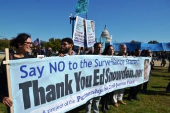 PCJF supporters holding a banner that says "Thank You Ed Snowden"