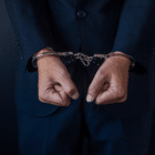 Hands clenched in fists and handcuffed