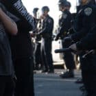 Photo of people standing in front of a line of California Highway Patrolmen.